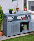 All in One Acacia Wood Outdoor Storage Cabinet With Two Magnetic Doors Weatherproof shown on a patio with plants and decor