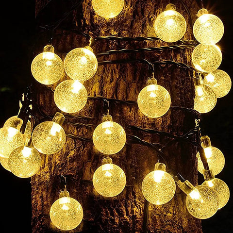 Two Pack Outdoor Solar String Lights With 60 LED Warm White Glow 40 Feet Of Durable String Lights wrapped around tree