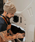 Hella Slick Camper Van Insulation Panels Deliver Top Tier Thermal Soundproofing Wrap For Custom Builds featuring installation process on van door.