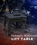 Beefy Heavy Duty Hydraulic Motorcycle Lift Jack For Dirt Bikes And ATVs, compact steel frame with wheels in garage setting