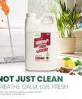 Aromatherapy Cleaning Concentrate 64 Ounce All Purpose Multi Surface Cleaner displayed in a kitchen setting with mop and plant.