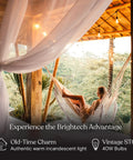 Woman relaxing in a hammock on a deck with 48 Ft Outdoor String Lights With 15 Vintage Filament Bulbs Dimmable Warm White Patio Lights above.