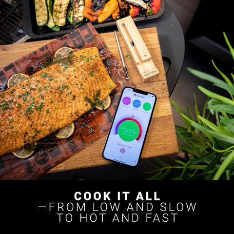 Wireless Meat Thermometer Pro For Grilling And Cooking With Bluetooth App showing salmon temperature on cutting board