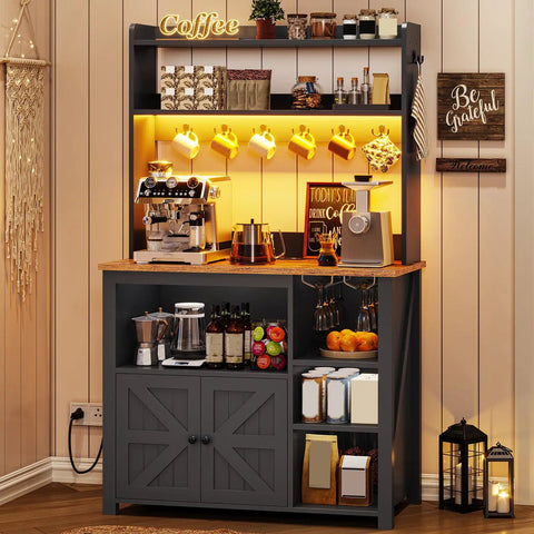 35.4 Inch Coffee Bar Cabinet With Power Outlet And Storage, Boss Level Farmhouse Microwave Stand With Hutch, LED Lights, Wine Glass Holder And 8 Hooks, Black Kitchen Organizer For Countertop And Pantry displaying coffee accessories and storage.