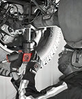 Mechanic using 1/2 Inch Air Impact Wrench Packin 960 Ft Lbs Of Raw Torque for tire removal under vehicle.