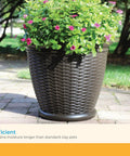 18 Inch Resin Wicker Planter For Indoor And Outdoor Use All American Style Durable Plastic Construction With Moisture Retention Brown Finish Weather Resistant Made In USA placed outdoors with flowers