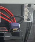 Heavy Duty 600 Amp Copper Bus Bar Power Distribution Block Featuring Nickel Plated 3/8 Terminals mounted on battery cables.