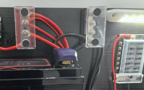 Heavy Duty 600 Amp Copper Bus Bar Power Distribution Block Featuring Nickel Plated 3/8 Terminals mounted on battery cables.