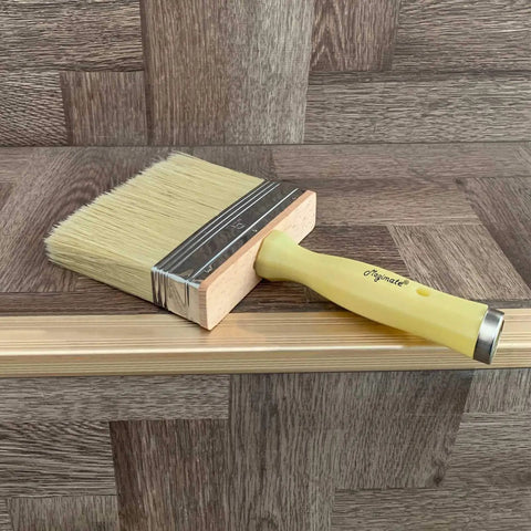 Heavy Duty 5 Inch Paint Brush With Screwed Extended Handle For Decks And Fences Stain Block Poly Bristle Blend on wood surface.