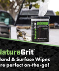 NatureGrit Hand & Surface Wipes canister with green label and a pulled wipe on a truck bed.