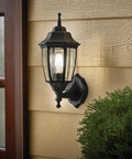 Photocell Dusk To Dawn Outdoor Wall Light With Weatherproof Die Cast Aluminum And Glass Hands Free Auto On Off Wet Location Rated E26 Base 60W Max Ideal For Porch Garage And Garden Black Finish mounted on wall next to door.