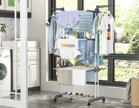 Top Shelf Oversized Four Tier Clothes Drying Rack With A Built Tough Foldable Frame Plus Side Wings For Hanging Laundry Towels Shoes And Quilts Roomy Air Drying Setup displaying clothes and towels indoors.