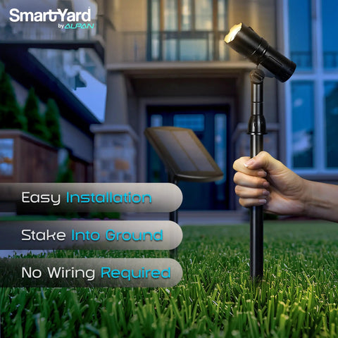 Person installing Outdoor Solar Spotlight Set Two Pack With Fifteen Inch Panel Waterproof LED Easy Install in garden