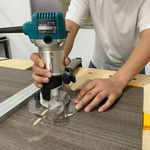 User operating a router with a Six Inch Round Clear Acrylic Router Base Plate Straight Swap For RT0701C Or XTR01Z Models With Pre Drilled Holes.