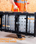 Person carrying folded Heavy Duty Welding Table With 1000 Lb Load Capacity, Folding Metal Workbench for Welding.