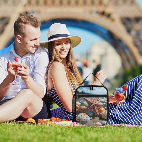 Couple enjoying picnic with Colorful Starfish Beach Lunch Box Insulated Tote With Side Pocket, outdoors on grass