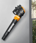 Leaf blower attached to a wall, mounted with Heavy Duty Wall Mount Tool Holder for Garage and Workshop Holds Your Tools Securely Up To 33 Pounds