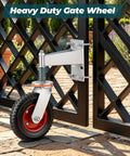 Built Tough Eight Inch Heavy Duty Fence Gate Wheels Featuring Spring Loaded Pivoting Rollers And Premium Double Ball Bearings For Smooth Rural Ranch Property Movements mounted on a black gate.