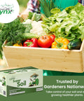 Person holding a wooden crate of fresh vegetables beside the box of All In One Garden Soil Test Kit For DIY Home Growers Super Easy To Use.