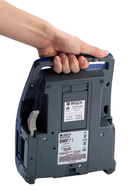 Hand holding the Straight Up Heavy Duty Desktop And Portable Label Printer With Quick Charge USB for easy transport.