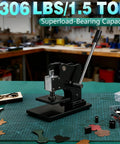 1.5 Ton Leather Die Cutting Machine With 12x9cm Leather Hand Press on a crafting table in a workshop setting.