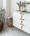 Wealth And Longevity Brass Cabinet And Furniture Pulls Set Of 2 in 2 inches wide on white drawer in interior setting.