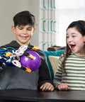 Children using Ultra Dope Hands-On Hydraulic Cyborg Hand Kit For Stem Fans to grab a purple ball, showing hydraulic gripper in motion.
