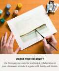 Art Dice Prompts Set Of Nine Wood Dice For Drawing And Painting Inspiration, Color Coded, One Inch Each, Roll To Kickstart Creativity And Bust Artist Block With Easy Read Prompts. Wood art prompt dice beside watercolor painting and paint tubes