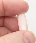 Premium Pink Calcite Faceted Tube Beads 20x10mm held between fingers, showcasing the natural stone texture for jewelry making.