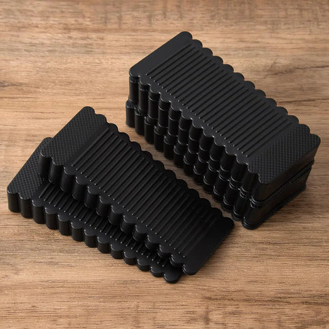 Rock Solid Black Rubber Wedge Shims For Furniture Leveling Hella Sturdy Anti Slip Wobble Pads stacked on a wooden surface.