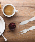 Stainless Steel Cheese Knife Set With Butter Spatulas And Spreaders For Camping And Outdoors on wooden table with coffee and jam