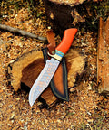 Dope Copper Damascus Fixed Blade Knife With Resin Handle and Premium Leather Sheath on wood surface in outdoor setting