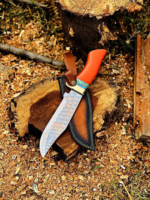 Dope Copper Damascus Fixed Blade Knife With Resin Handle and Premium Leather Sheath on wood surface in outdoor setting