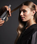 Stylist using Polished Silver Japanese Steel Hair Cutting Shears With Beveled Blade For Wet And Dry Hair on woman's long hair