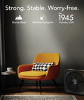 Living room scene with a High Velocity Box Fan With Removable Grille, 5 Speed Settings, positioned on the floor next to an orange chair.
