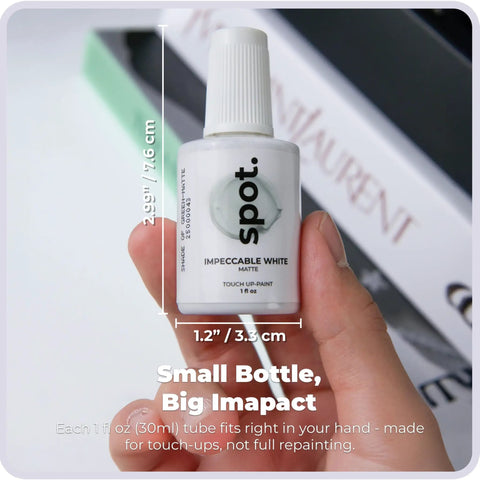 Hand holding Three Shade Matte White Touch Up Paint Kit For Cabinets Walls Doors And Furniture With Quick Dry Easy Fix Self Priming Low Odor Eco Friendly No Sanding Needed Three Pack That Matches Ninety Percent Of Surfaces small bottle label