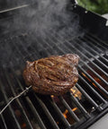 Fast Read Three Sensor Grill Probe Wired For Food Temperature With Slim Design For Searwood Smoque And Summit Grills Built Tough To Handle Up To 572 F For Grill Masters inserted into steak on grill