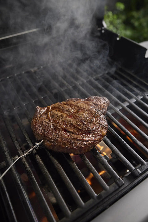 Fast Read Three Sensor Grill Probe Wired For Food Temperature With Slim Design For Searwood Smoque And Summit Grills Built Tough To Handle Up To 572 F For Grill Masters inserted into steak on grill