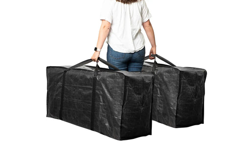 Person carrying XXL 68.5 Gallon Heavy Duty Storage Bags Two Pack With Mega Strong Wrap Around Handles Zippered Reusable Moving Totes