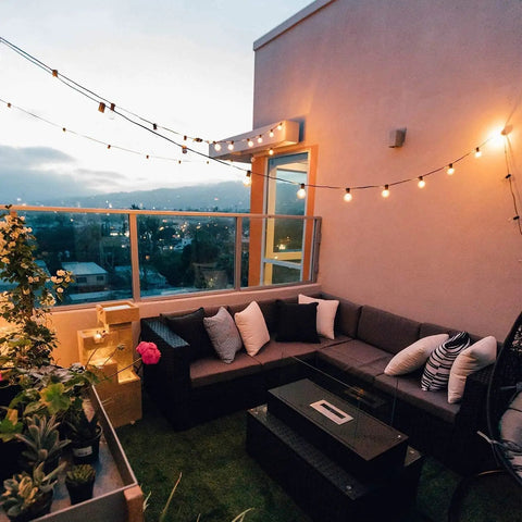 Outdoor String Lights 50ft Connectable Patio Lighting With 52 G40 LED Bulbs Warm White 2200K on balcony at sunset