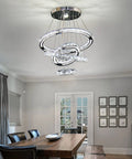 LED Crystal Chandelier With 4 Ring Design illuminating a dining room, featuring modern stainless steel and adjustable rings up to 47 inches.