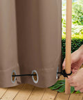Person securing Two Panels Weighted Blackout Outdoor Curtains For Patio And Pergola Waterproof And Thermal Insulated With Top And Bottom Grommets And Back Tab Wind Resistant Privacy Drapes In Tan Khaki 52 By 84 Inches to a pole