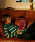 Smooth 11 Inch Tablet With Blazing A16 Chip, Gorgeous Liquid Retina Display, 128GB Memory, Rapid Wifi 6 Connectivity, Crisp Front And Rear Cameras, Rock Solid Touch Id Security, Plus Dazzling All Day Juice In Clean Blue in use on a couch.