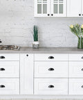 Three Inch Cup Drawer Pulls Set Of Five In Flat Black Modern Kitchen Cabinet Handles Hardware with smooth scratch-resistant finish on white cupboards.