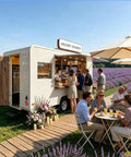 Built Different 18 Foot White Prefab Food Trailer For Catering Hustles Featuring Slick Service Windows in a lavender field.