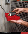 Person using Industrial Grade Heavy Duty Plug Lockout Device for Lockout Tagout, securing plug in red nonconductive polypropylene case.