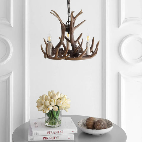 Brown Adjustable Resin Antler Three Light LED Chandelier over table, cozy farmhouse vibe faux antler hanging light for dining room.
