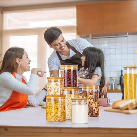 Family in kitchen with Airtight Glass Storage Jars Set Of 7 With Bamboo Lids For Pasta Cookies Nuts Coffee Beans Cereal Flour Pantry.