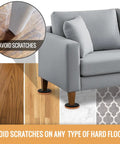 Heavy Duty Felt Furniture Sliders For Hardwood Floors And tile Pads Protecting Your Home From Scratches While Moving Sofas Dressers And Heavy Appliances With Ease In This Eight Pack Set, shown under a gray couch.