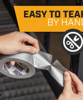 Silver Duct Tape 6 Roll Multi Pack, 90 Feet Each, 2 Inch Wide Heavy Duty Waterproof Tape being torn by hand